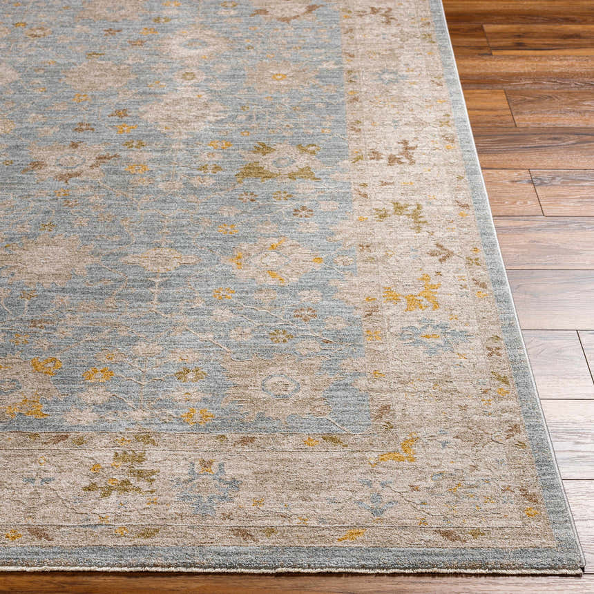 Close-up of the Kofi Thick Luxe Area Rug with a traditional design in amber, brown, olive, gray, mustard and taupe. Front