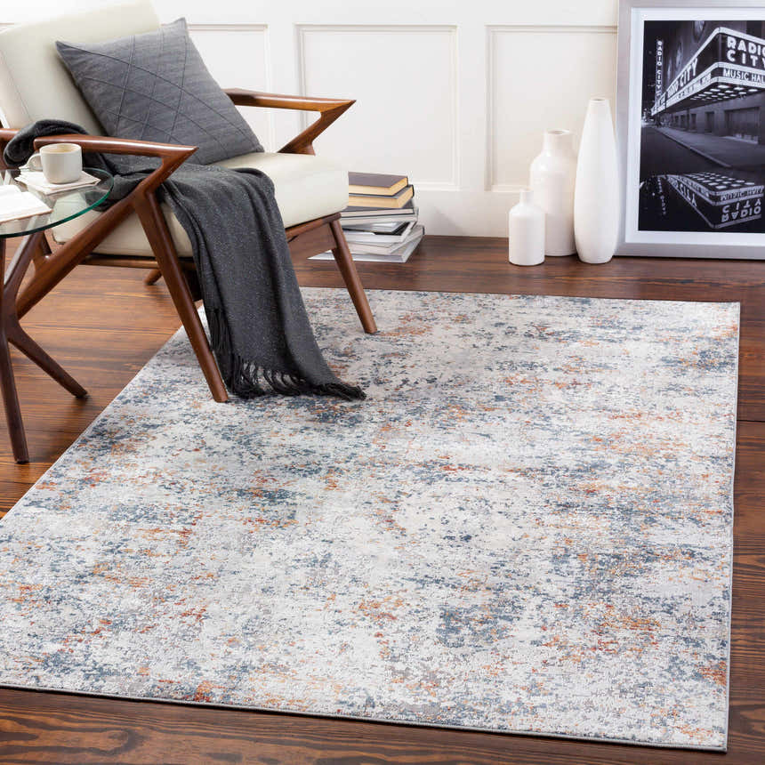 Living room scene with a Kearny Area Rug in brick red, brown, charcoal, light beige, and light gray colors. Roomscene-Rectangle