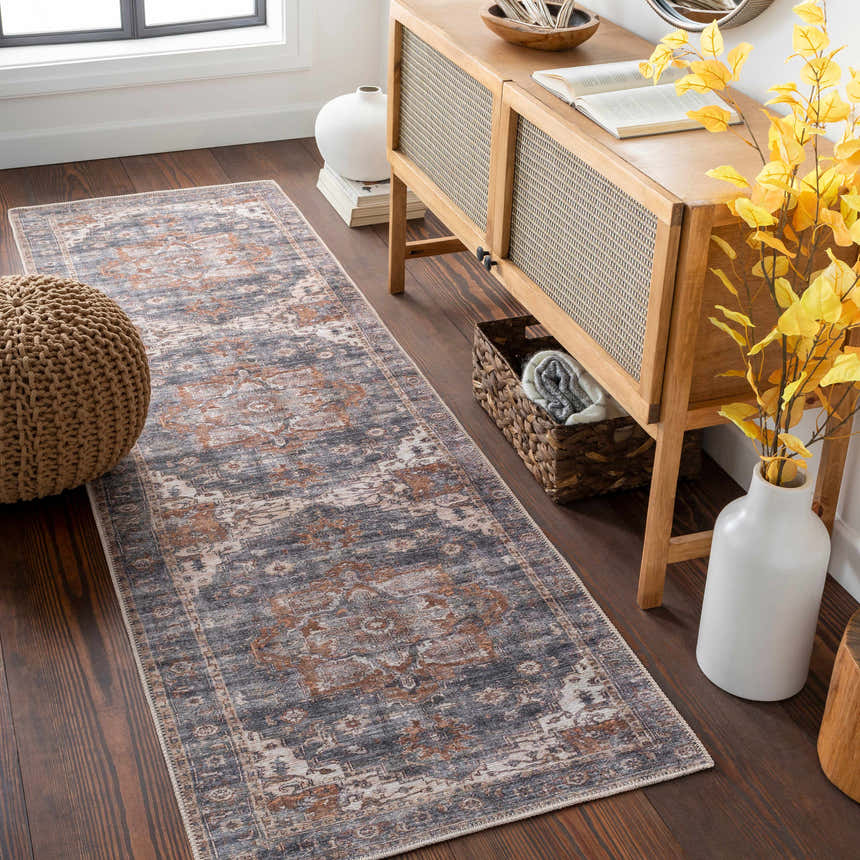 Entryway scene with a Lagangilang Washable Area Rug, wood console table, pouf, and hardwood floors. Beige, gray, and brown tones. Roomscene-Runner