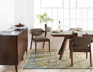 Dining room scene with a blue and olive Latour Carpet, wood table and chairs, and white brick wall. Roomscene-Rectangle