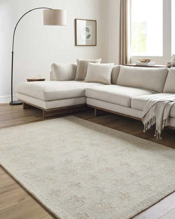 Neutral living room with a cream sectional and Lotta Peach Modern Wool Area Rug on wood floor. Roomscene-Rectangle