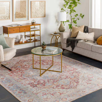 Living room scene with a Cream Rust Leeston Washable Rug, sofa, armchair, and gold accents. Bohemian style. Roomscene-Rectangle