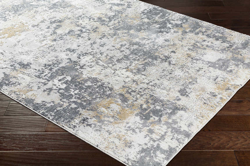 Close-up of Lenzburg Faux Silk Abstract Rug. Charcoal, gray, light gray, and mustard abstract pattern. Viscose rug. Corner