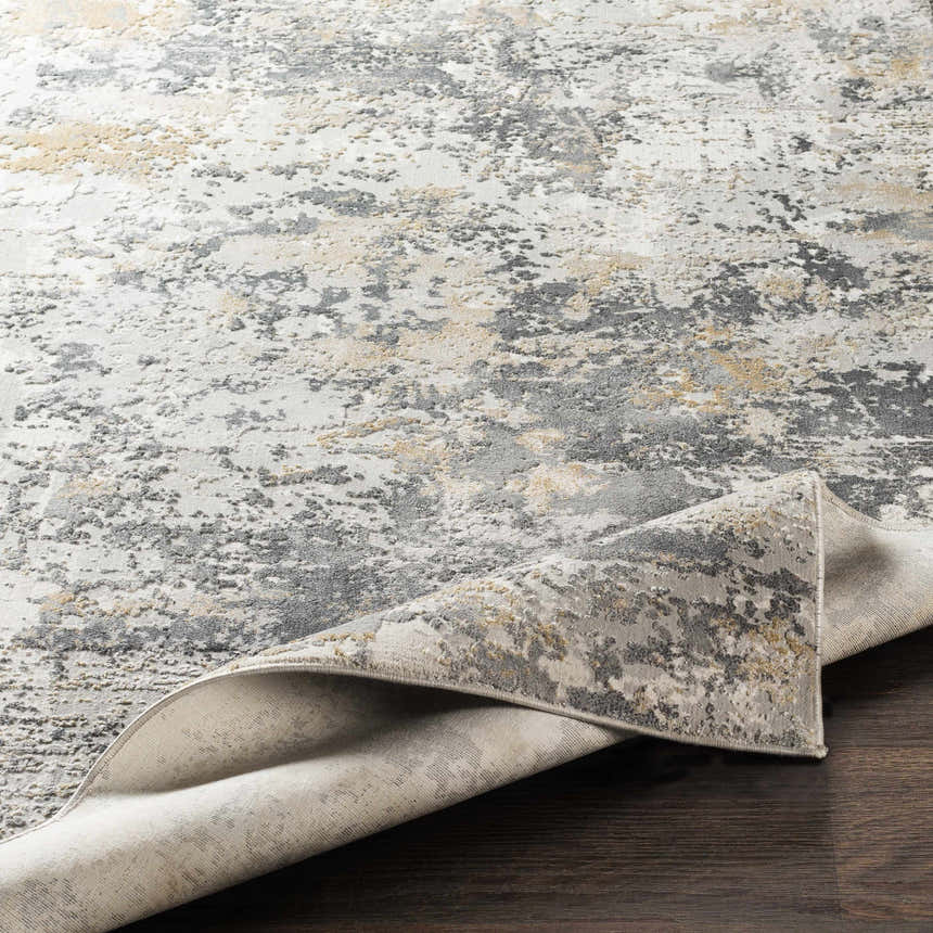 Close-up of Lenzburg Faux Silk Abstract Rug; charcoal, gray, light gray, and mustard abstract pattern and viscose texture. Fold