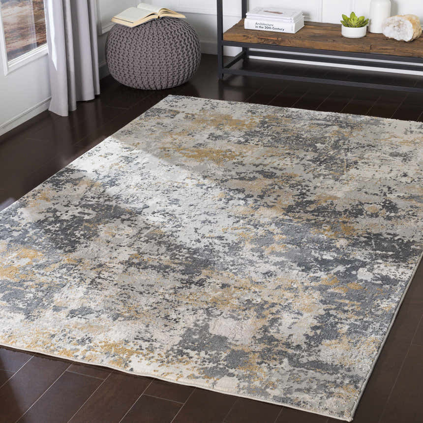 Living room scene with charcoal gray pouf and Lenzburg Faux Silk Abstract Rug in charcoal, gray, light gray, and mustard. Roomscene-Rectangle