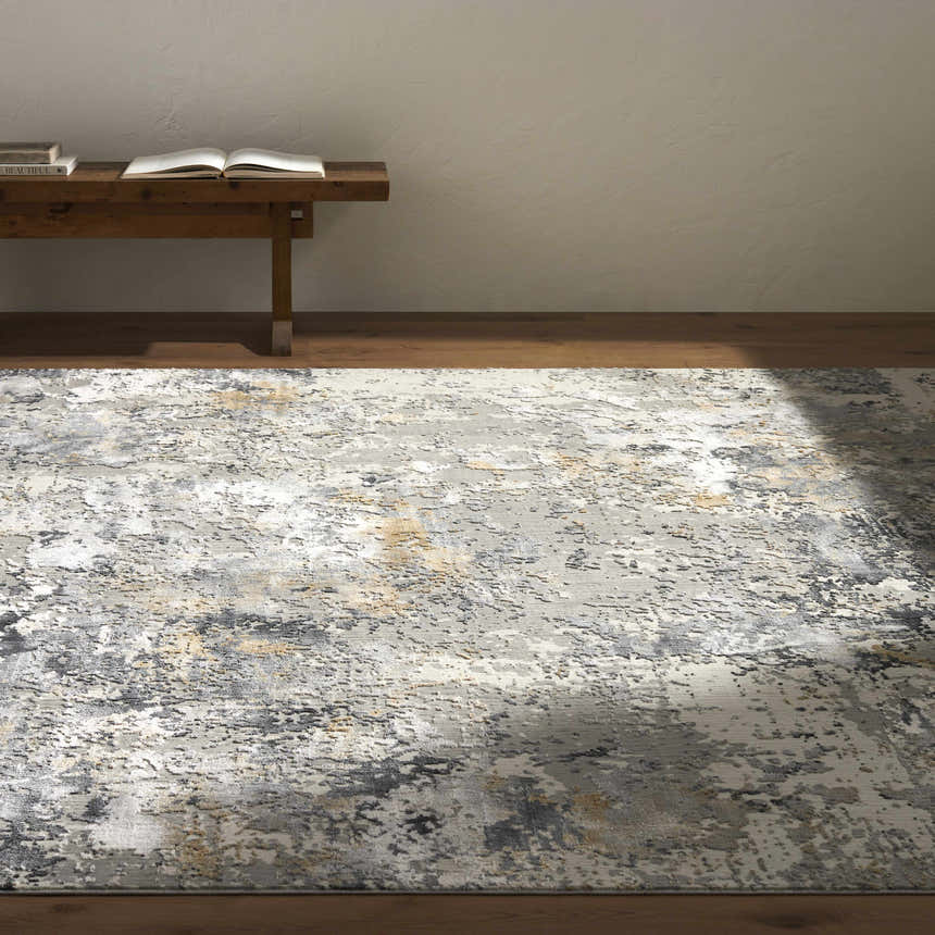 Minimalist room with a Lenzburg Faux Silk Abstract Rug in charcoal, gray, light gray, and mustard. Styleshot