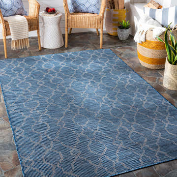 Patio scene with blue Lidlington Flatweave Area Carpet, wicker chairs, and natural textures for a cozy, contemporary farmhouse feel. Roomscene-Rectangle