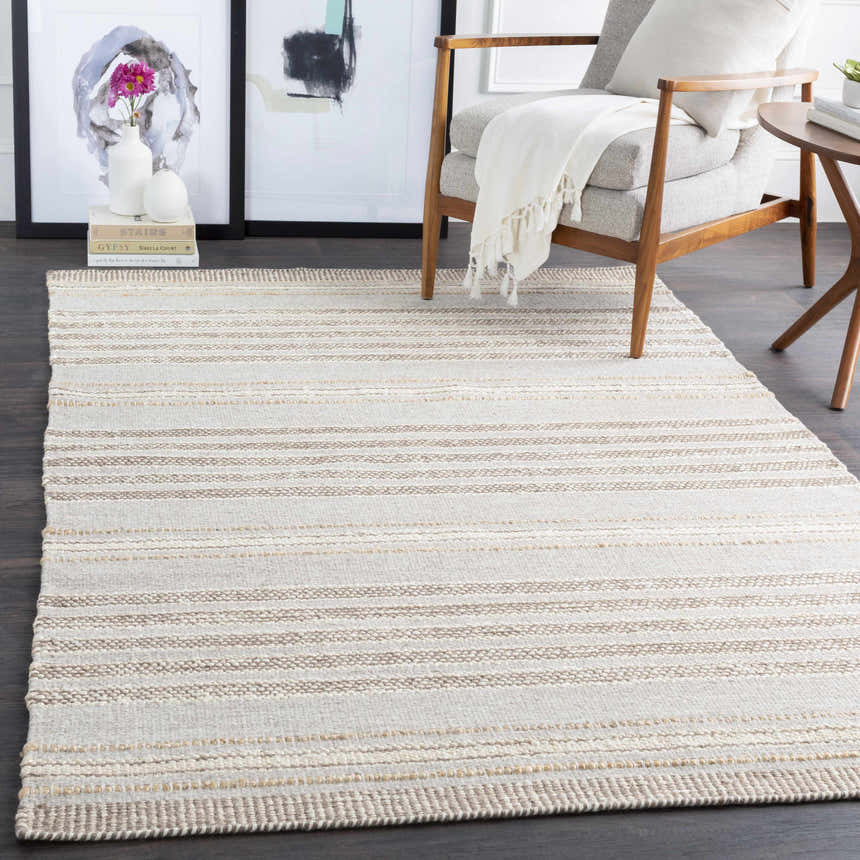 Scandinavian-style living room with a beige and cream striped Allendorf Area Rug, gray chair, and wood accents. Roomscene-Rectangle