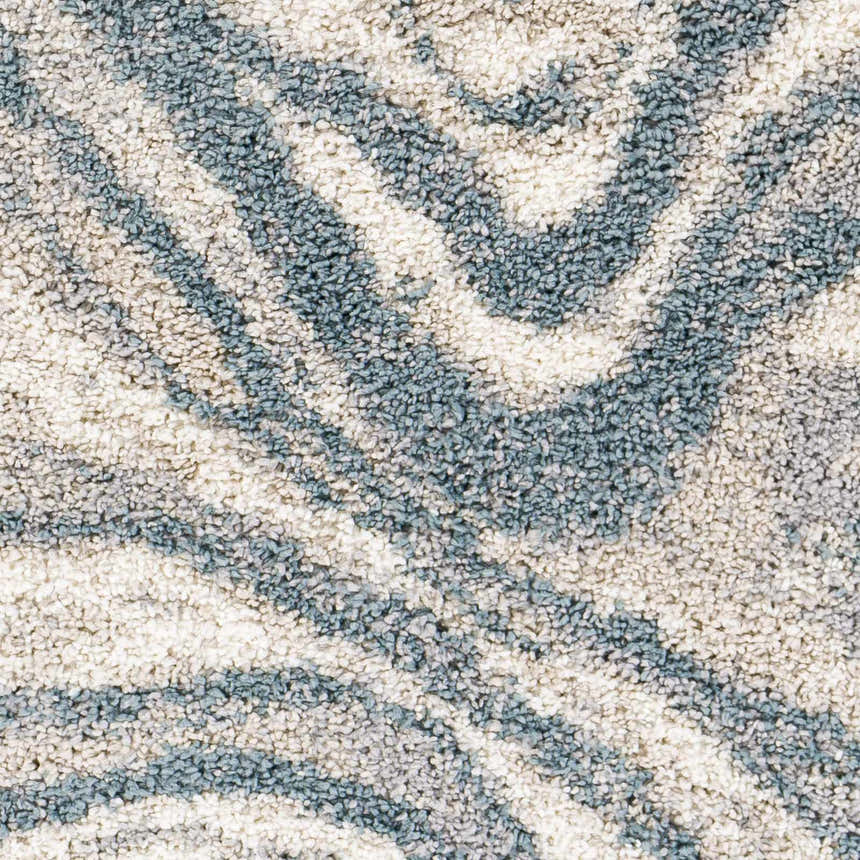 Close-up of the Lottery Area Rug showing a blue and cream abstract shag pattern. Swatch