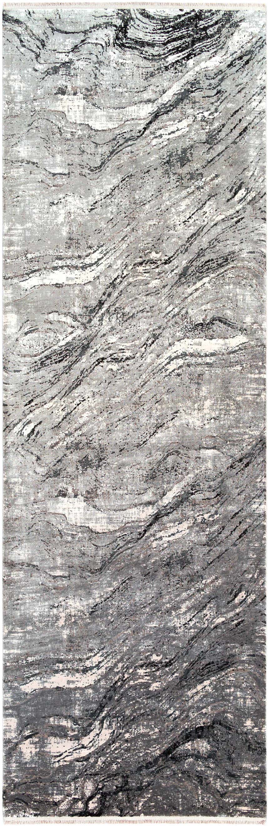 Close-up of the Littleport Luxury Fringed Faux Silk Rug. Abstract design in black, charcoal, gray, and light gray tones. Design-Runner