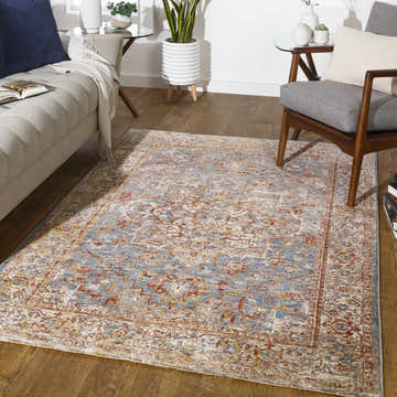 Living room scene with a Brick Red and Pale Blue Lumpkin Area Rug, sofa, and chair on a wood floor. Roomscene-Rectangle