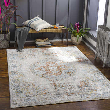 Cozy reading nook with the Ely Area Rug. The rug has brick red, charcoal, and cream tones. Roomscene-Rectangle