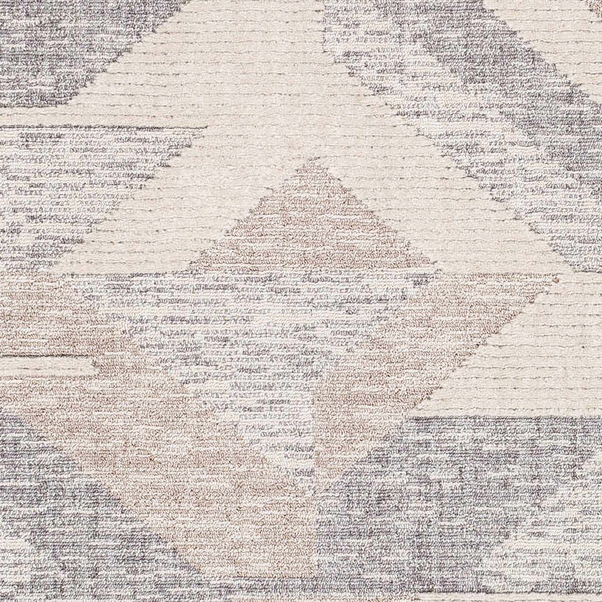 Close-up of the Magazine Geometric High/Low Pile Rug. Tan, gray, and cream diamond pattern. Bohemian style rug texture. Swatch