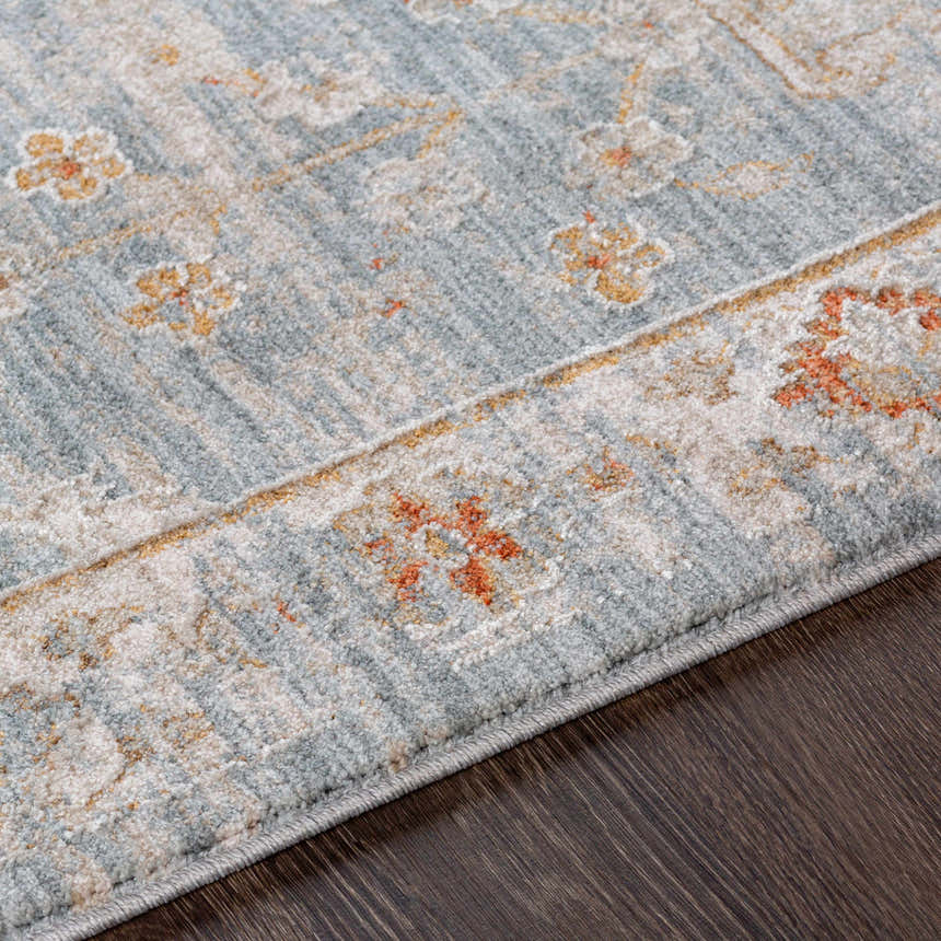 Close-up of the Mangham Thick Luxe Area Rug, showcasing its blue, beige, and rust floral pattern and soft, thick texture. Texture