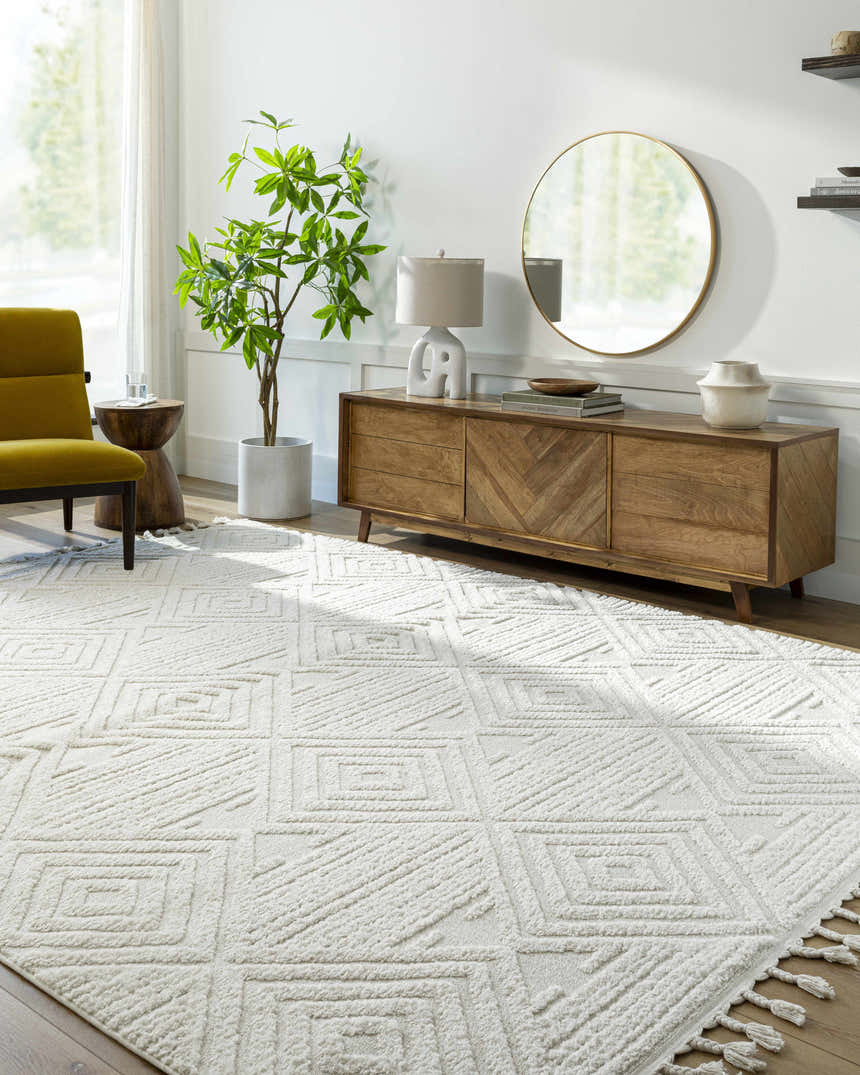 Living room with a Bone Manyas 3D Area Rug, wood console table, round mirror, and olive green chair. Roomscene-Rectangle