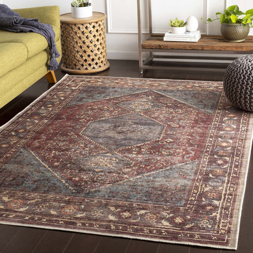 Living room scene with a traditional Maplesville Washable Area Rug. The rug has beige, pink, plum, and teal colors. Roomscene-Rectangle