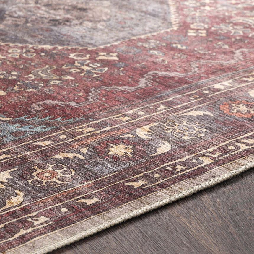Close-up of the beige and rust Maplesville Washable Area Rug showing its traditional, machine-woven design and polyester texture. Texture