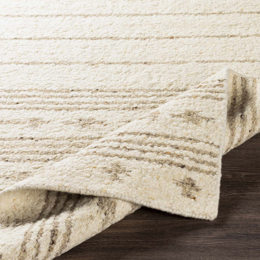 Close-up of the ivory Matawan Premium Wool Rug with a horizontal striped pattern and hand-woven texture. Fold