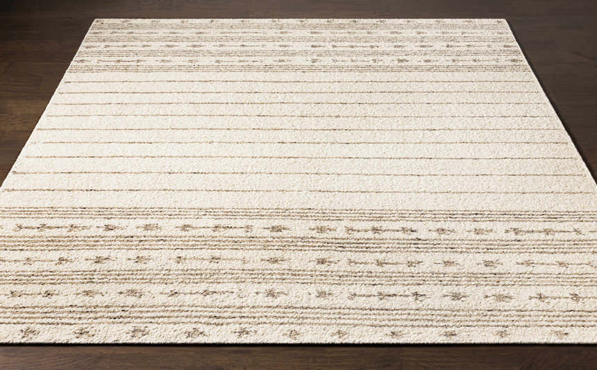 Close-up of the Matawan Premium Wool Rug. Ivory rug with brown stripes and geometric pattern. Hand-woven texture. Front