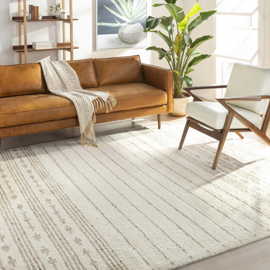 Living room with brown leather sofa and cream Matawan Premium Wool Rug with subtle stripes. Roomscene-Rectangle
