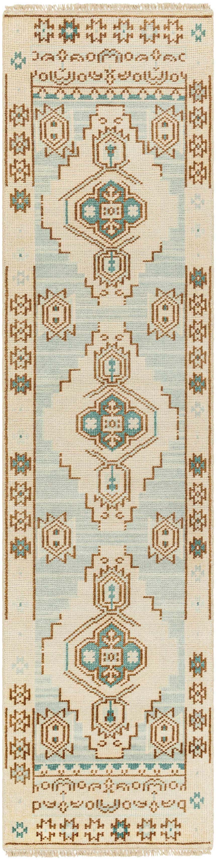 Close-up of the McColl Hand Knotted Wool Blend Rug, featuring a cream, brown, and teal geometric pattern. Design-Runner-2610