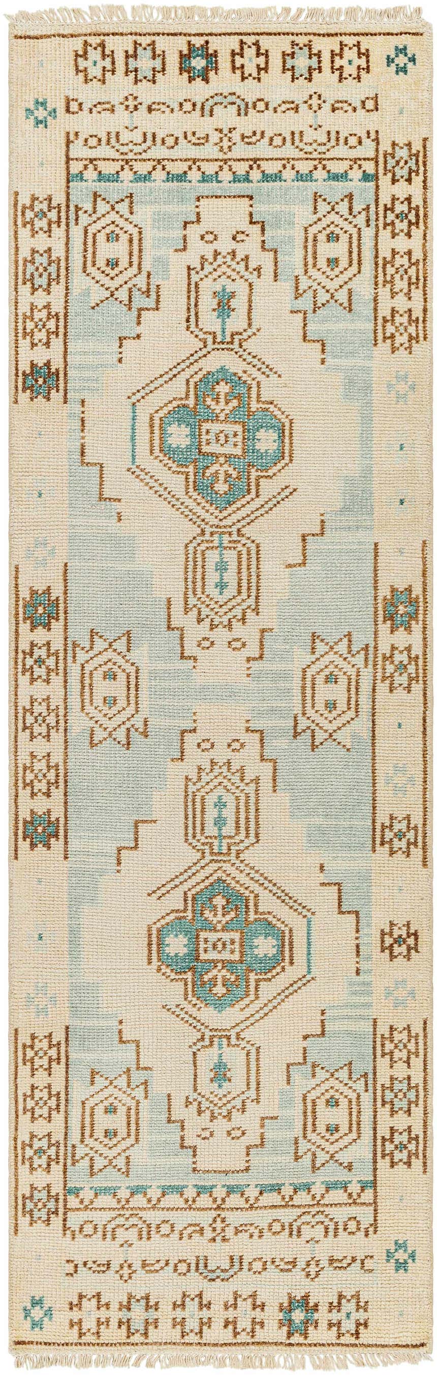 Close-up of the hand-knotted McColl Wool Blend Rug. Features brown, cream, and teal geometric patterns and fringe. Design-Runner-268