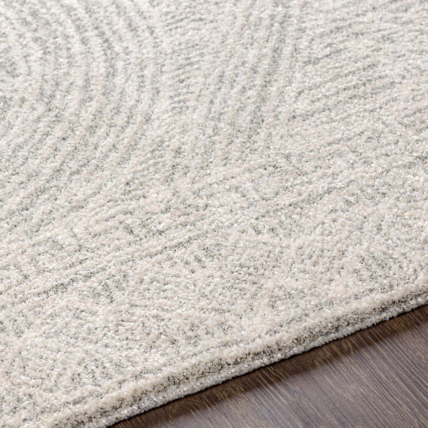 Close-up of the textured Middleville Luxe Rug. Contemporary design in charcoal, cream, light beige, and light gray. Texture