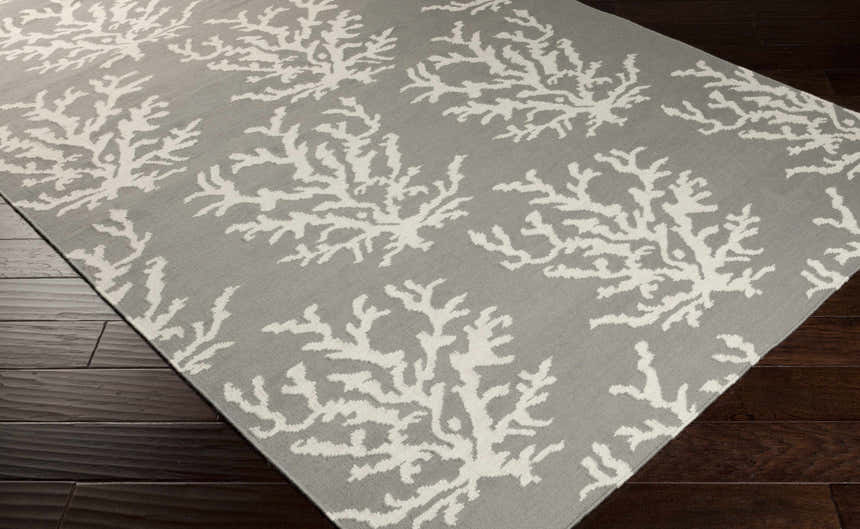 Close-up of the Merchantville Area Rug. Ivory coral pattern on light gray 100% wool rug. Hand woven texture. Corner