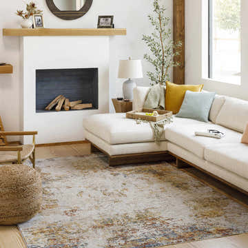 Living room scene with a Middelburg Rock Pattern Luxe Area Rug, cream sofa, fireplace, and natural light. Roomscene-Rectangle