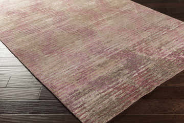 Close-up of the Midkiff Area Carpet. Hand-knotted viscose rug in gray, ivory, lilac, and off-white with a contemporary design. Corner