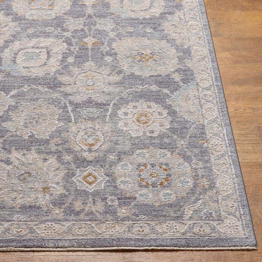 Close up of the Mimarsinan rug showing its gray, beige, and brown oriental pattern on wood flooring. Front