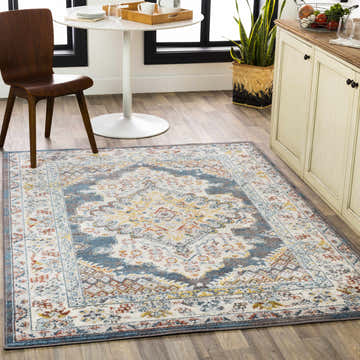 Bright kitchen scene with a blue, brown, and mustard Millican Area Rug under a round table and chair. Roomscene-Rectangle