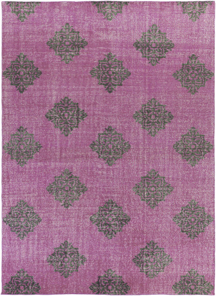 Close-up of the Mina Area Rug. Hand-knotted wool rug in fuchsia with a black medallion pattern. Design-Rectangle-811