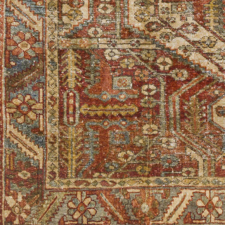 Close-up of the Mantalongon Washable Area Rug showing its traditional, oriental pattern in brick red, brown, and dusty sage. Swatch