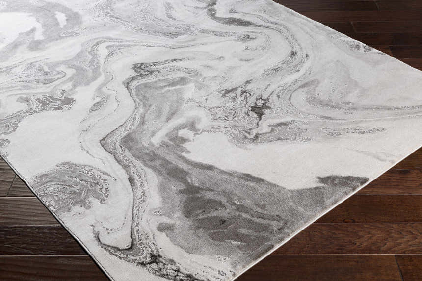 Close-up of the Moana Charcoal Marble Rug showing its gray and white swirling marble pattern and soft texture. Corner