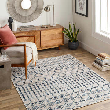Living room scene with a Modderfontein Washable Area Rug, light beige and blue geometric pattern, wood furniture, and modern decor. Roomscene-Rectangle