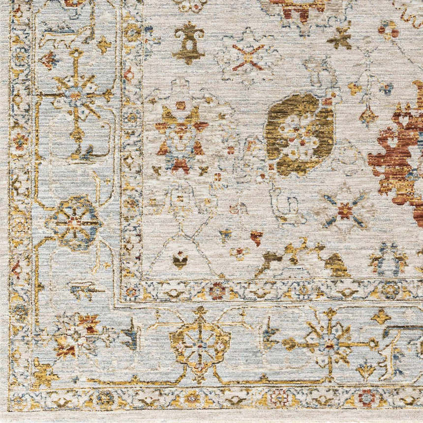 Close-up of the Mogul Luxe Oushak Rug, showcasing its traditional floral pattern in brick red, cream, denim, and mustard tones. Swatch