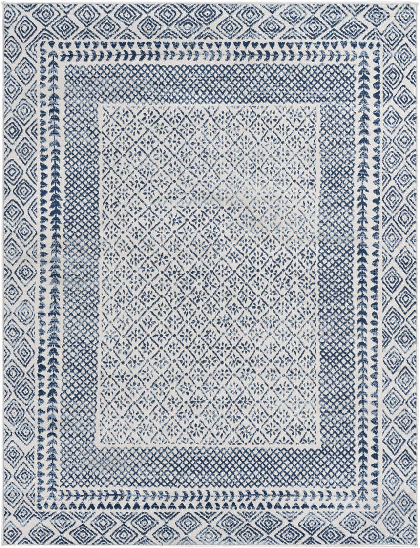 Close-up of Mohrsville Area Rug - Clearance. Machine-woven rug with geometric patterns in shades of blue on a white background. Design-Rectangle-537