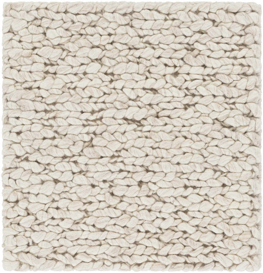 Close-up of the hand-woven Monticello Carpet. Light beige and dark brown wool rug with a chunky, braided texture. Swatch