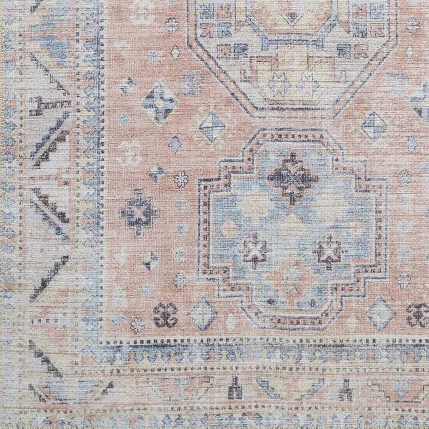 Close-up of the Morcott Peach Washable Area Rug. Features a traditional, oriental-inspired pattern in peach, blue, and ivory tones. Swatch