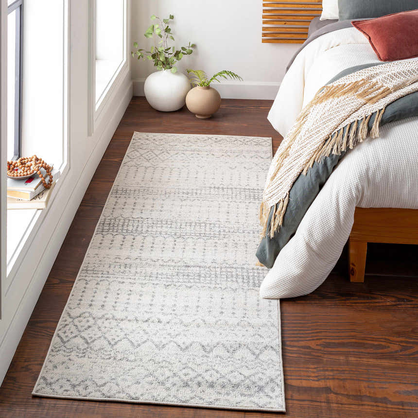 Bedroom scene with Moweaqua Area Rug in charcoal, gray, and ivory. Farmhouse style runner rug on wood floor. Roomscene-Runner