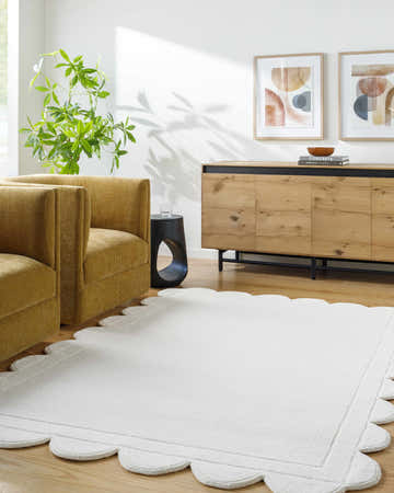 Living room scene with the Uhuro White geometric area rug, mustard chairs, and light wood accents. Roomscene-Rectangle