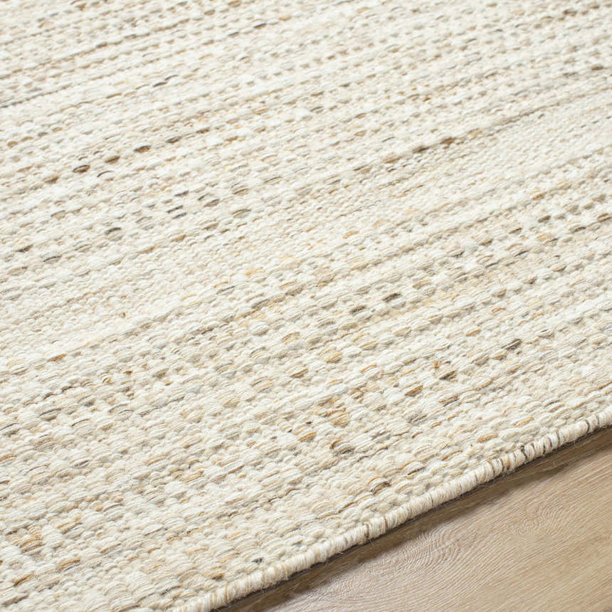 Close-up of the hand-woven Moshe Area Rug. Peach tones in a textured, farmhouse style wool rug. Texture
