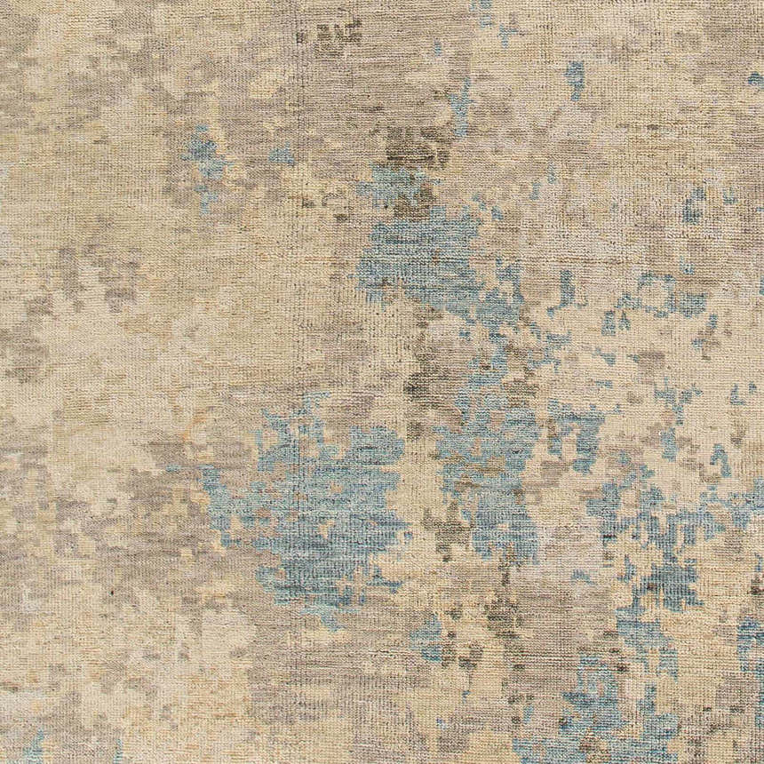 Close-up of the Marco Handmade Wool Rug showing charcoal, cream, denim, and light beige colors. Swatch