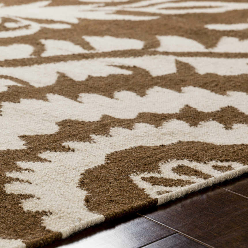Close-up of the hand woven Naeva Area Rug showing the dark brown and walnut contemporary pattern and wool texture. Texture
