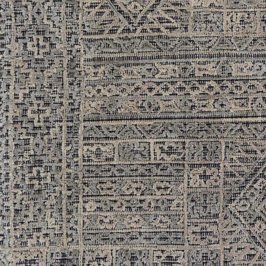 Close-up of the Nairne Textured Wool Area Rug. Bohemian style rug in black, gray, and taupe with geometric patterns. Swatch