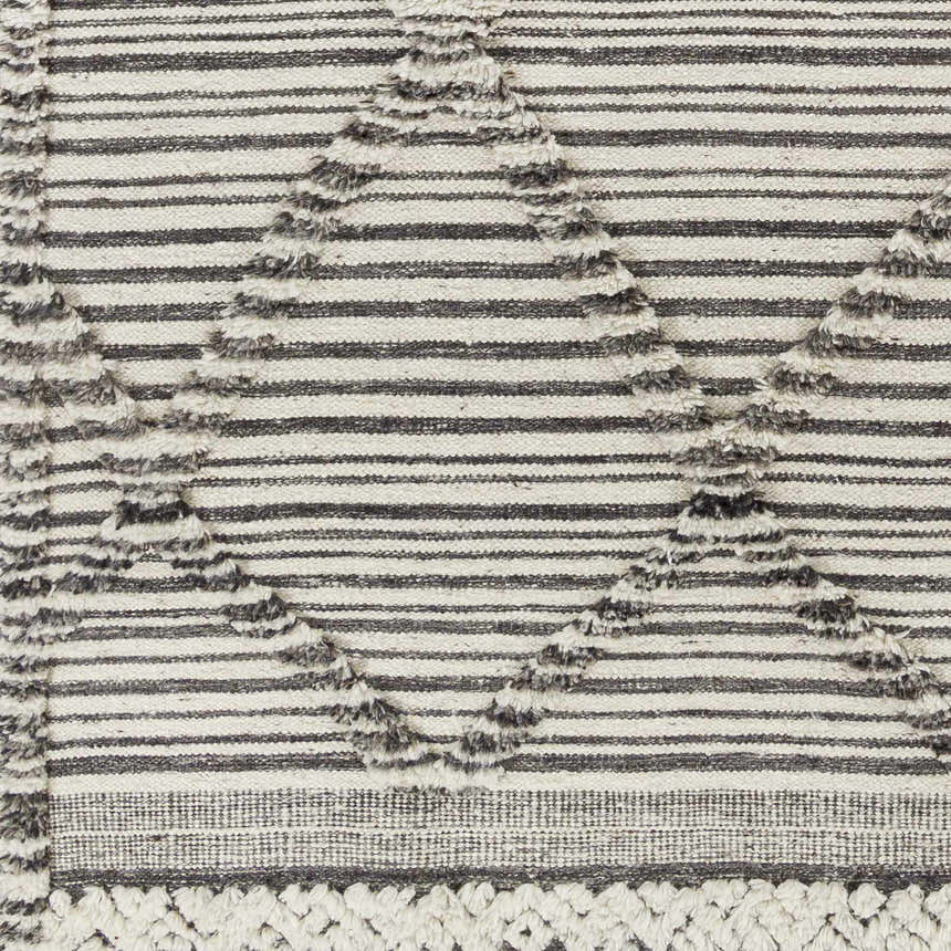 Close-up of the Nairobi Area Rug, a hand-knotted wool rug with black, gray, and ivory stripes and textured diamond accents. Swatch