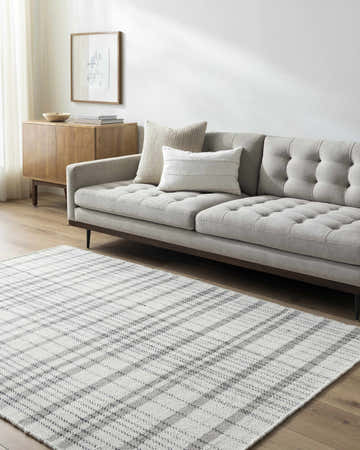 Living room scene with a gray sofa and the ivory Nissa Area Rug, a farmhouse style wool rug with a plaid pattern. Roomscene-Rectangle