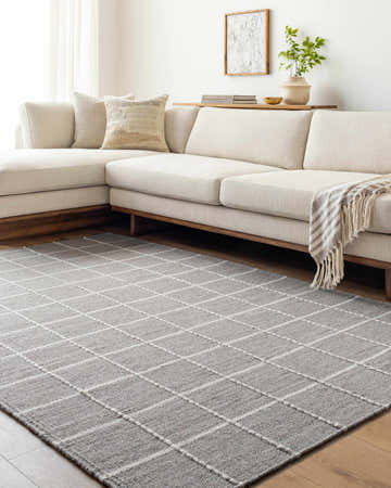 Neutral living room with a sectional sofa and the gray checkered Nissa Wool Rug. Roomscene-Rectangle
