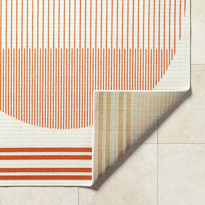Close-up of Nabil Cream Area Rug showing orange striped pattern and durable machine-woven construction. Fold